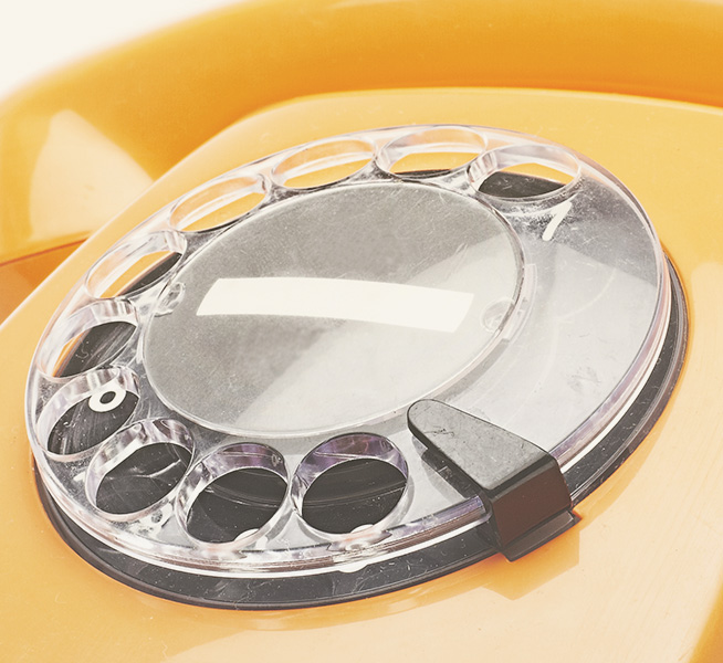 Close up of a yellow rotary phone